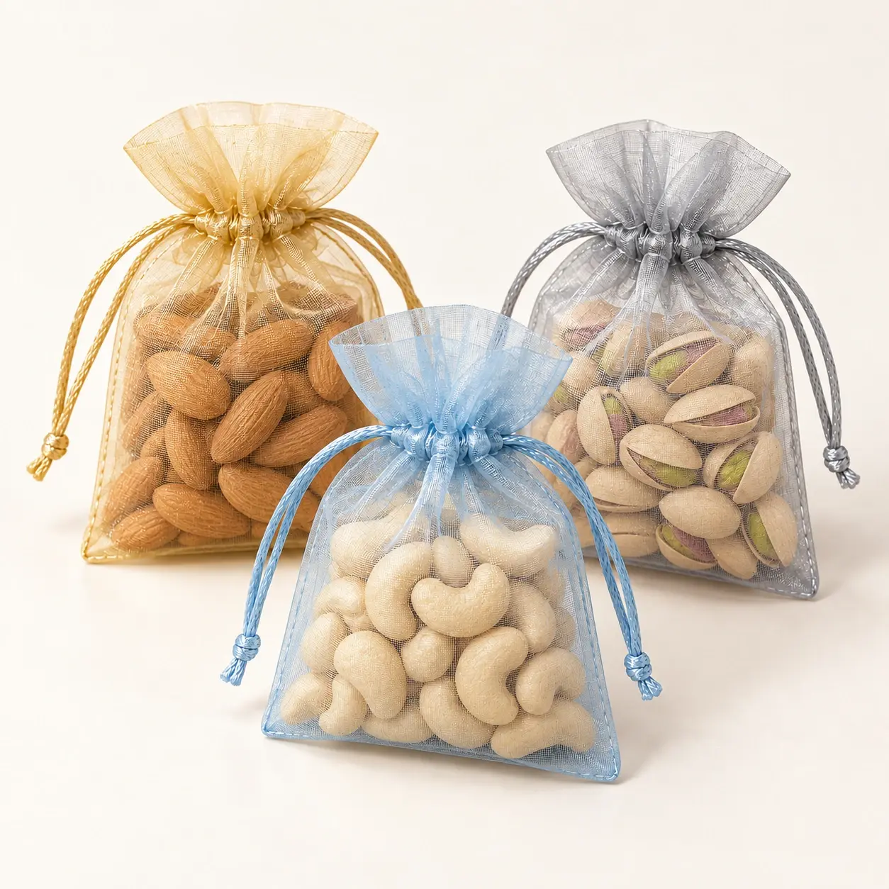 Organza Favour Pouch Trio filled hamper — Champagne, silver-grey and powder-blue organza pouches with neutral inserts